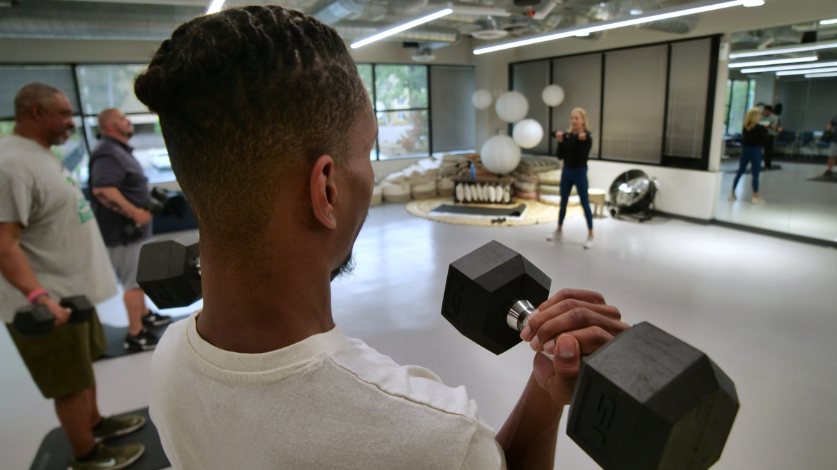 Member exercising with a dumbbell